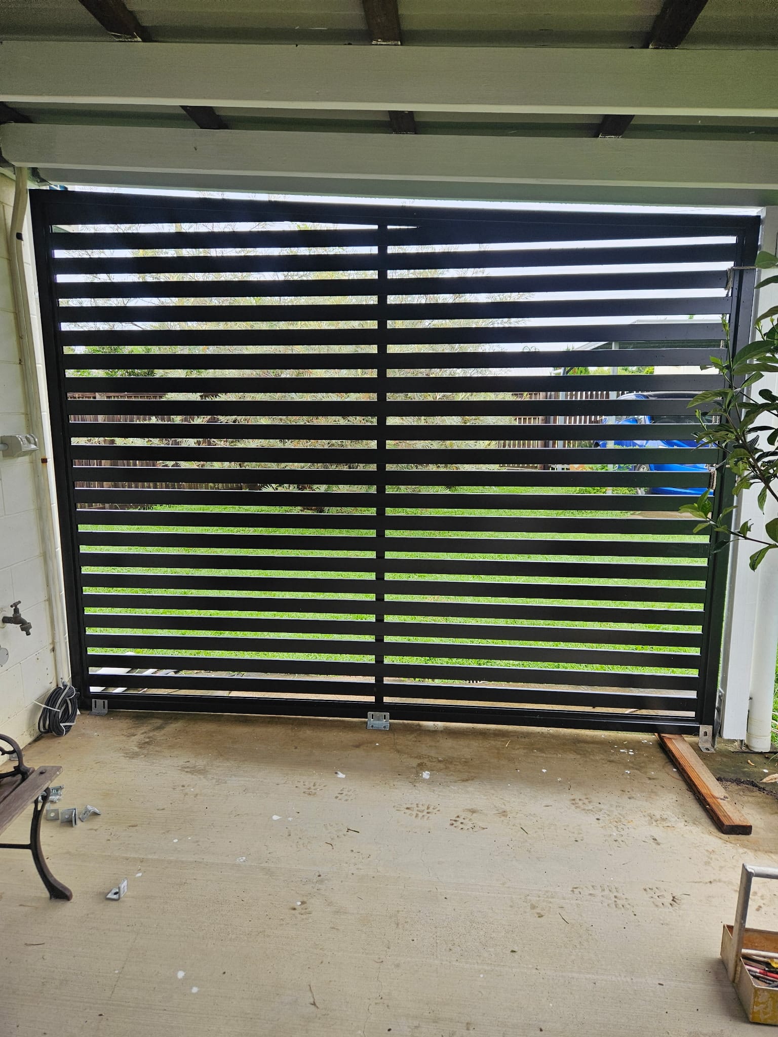 Black horizontal slat gate installation